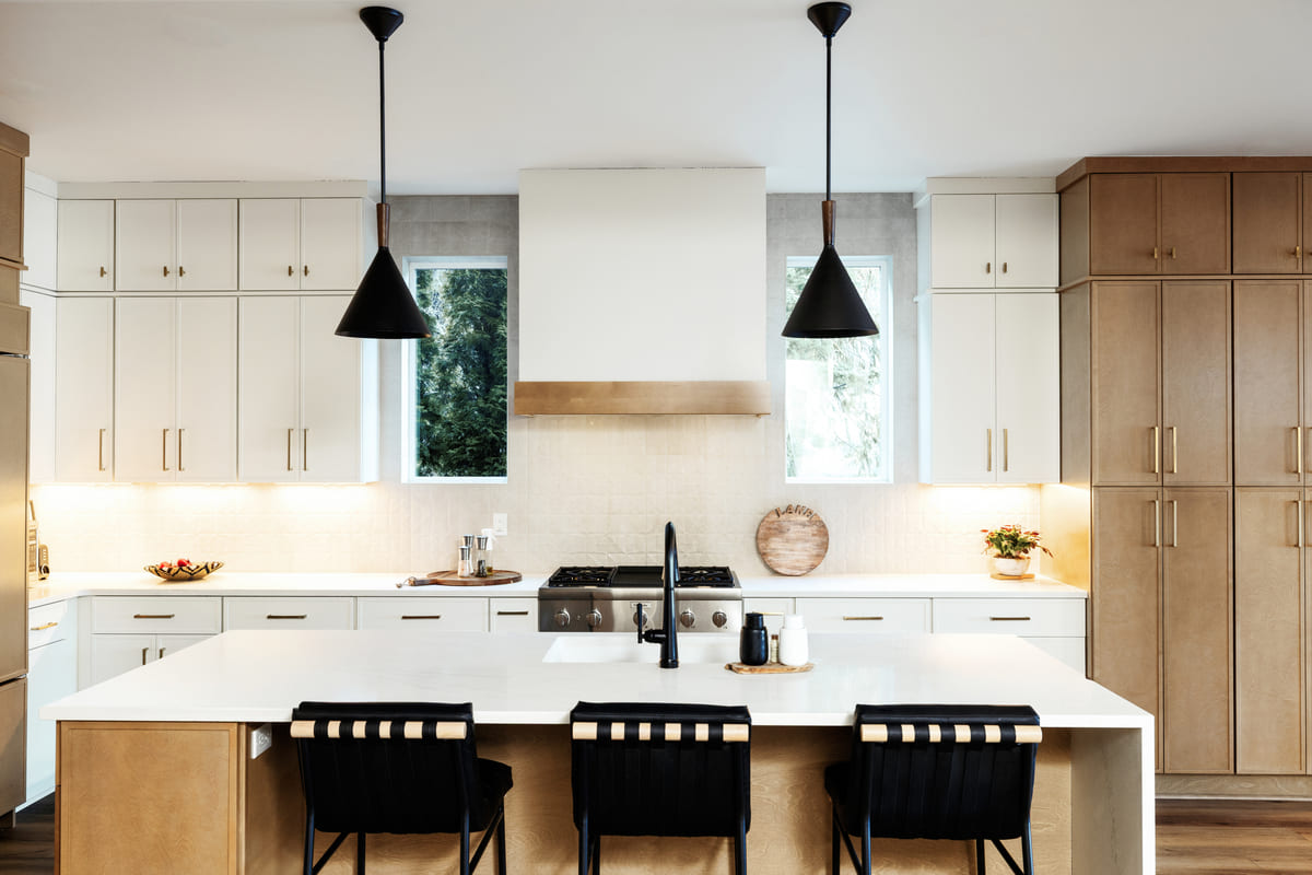 Modern kitchen featuring white cabinetry, warm wood accents, and sleek black fixtures for a minimalist and elegant look.