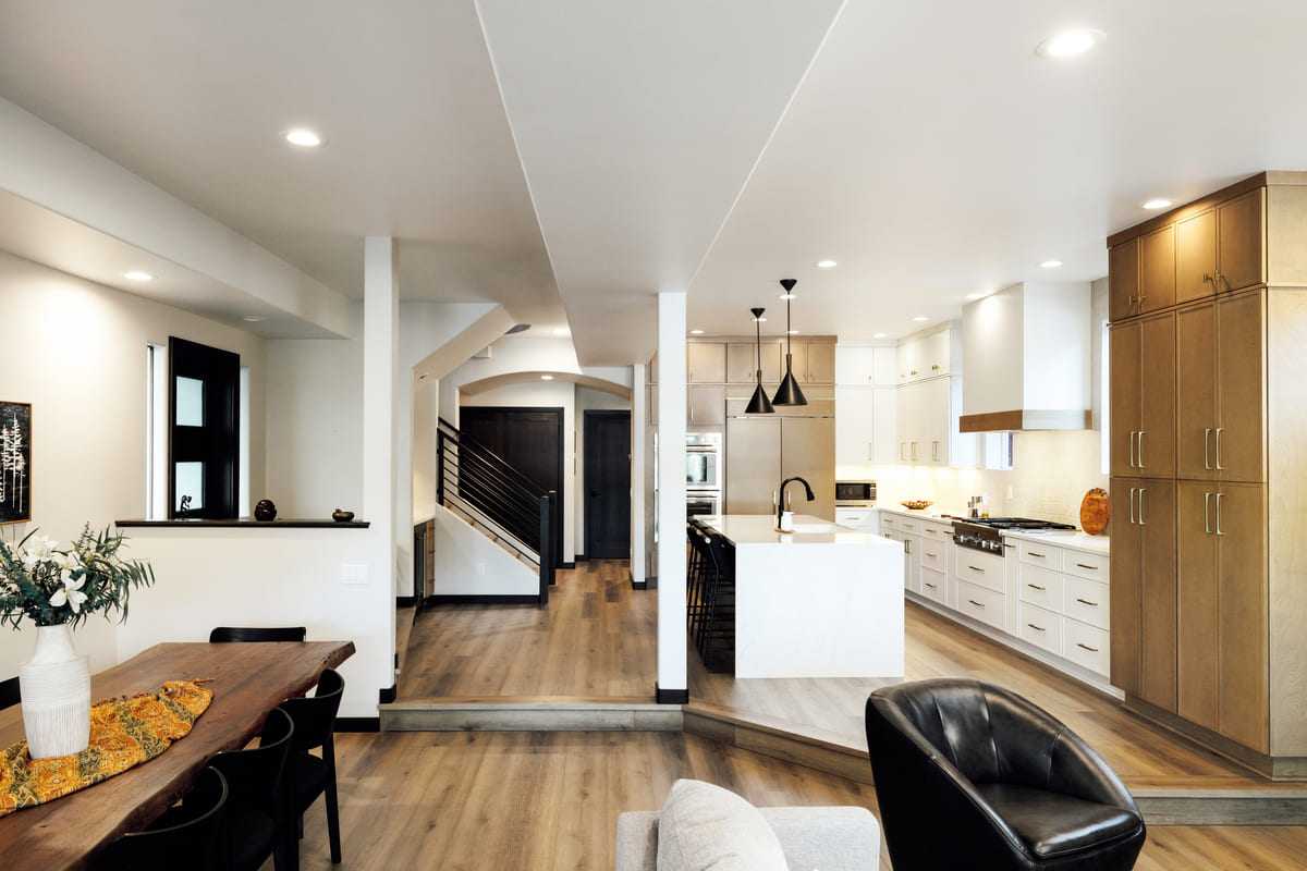 Modern open-concept living room remodeled by Kuster Homes, featuring natural light, sleek finishes, and spacious layout.