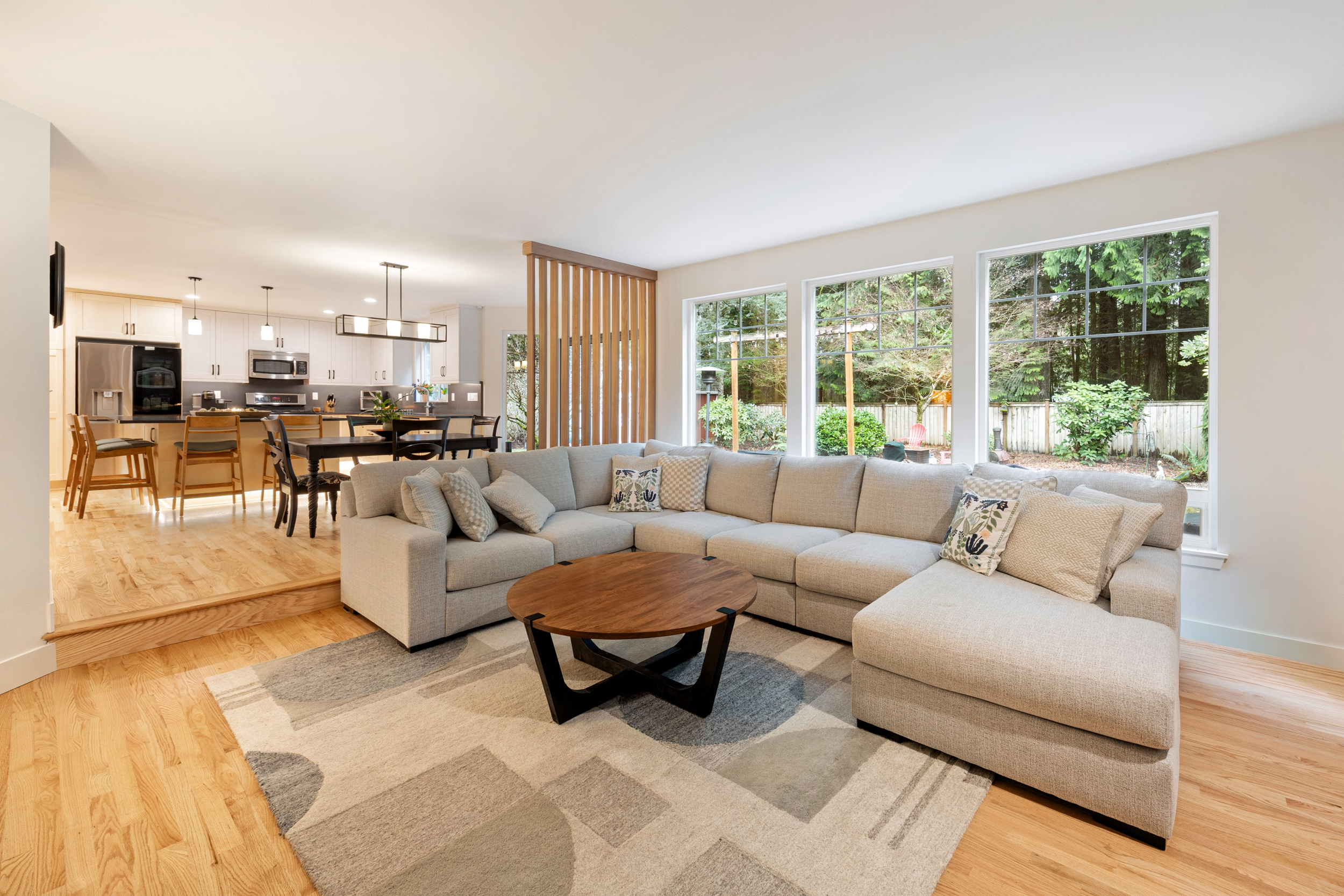 Open-concept living room in Olympia whole house remodel with modern fireplace and luxury finishes